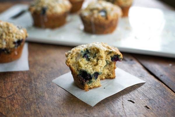 Oatmeal flax blueberry muffins on parchment paper.