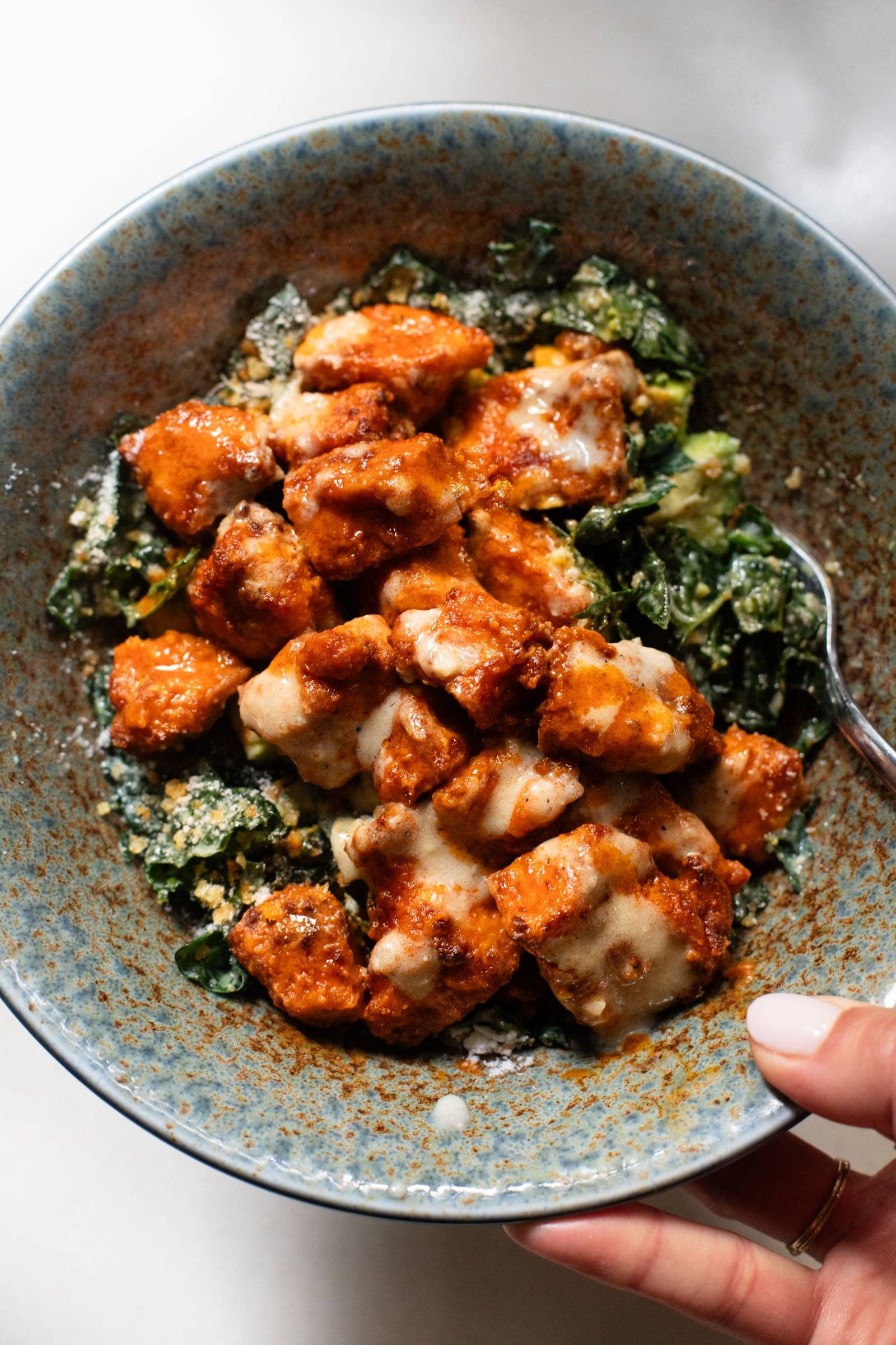Buffalo tofu on caesar salad.