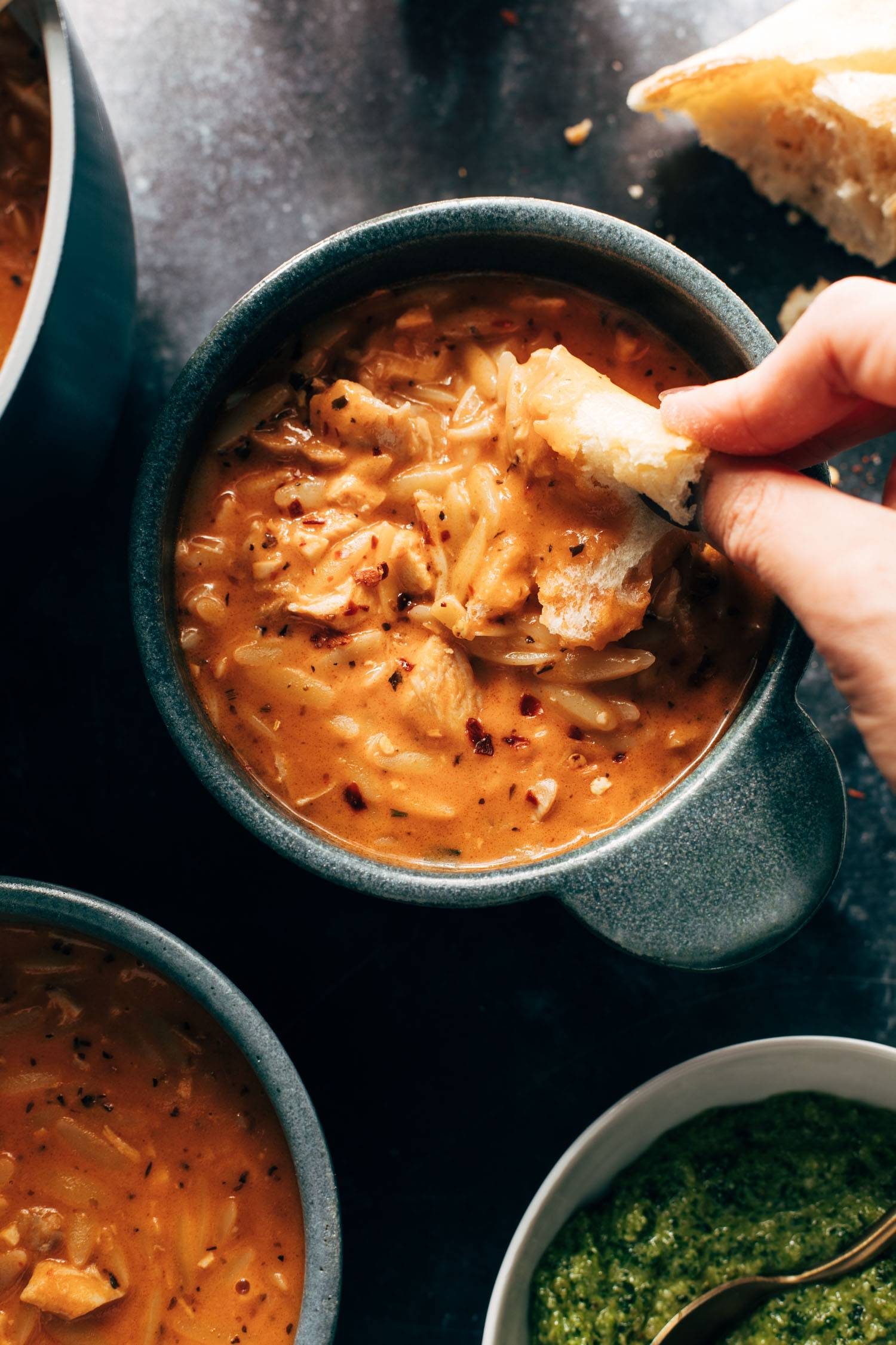 Chicken orzo tomato soup in a bowl.