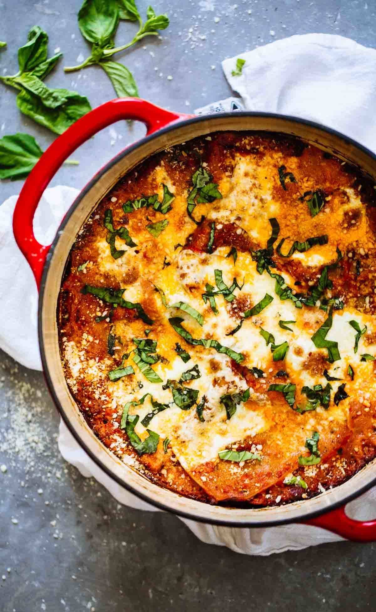 Lasagna in a red dutch oven.