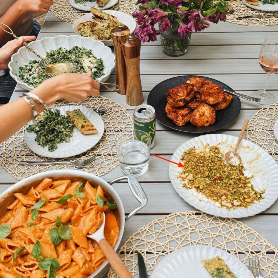 Dinner table with pasta, chicken, and boursin dip.