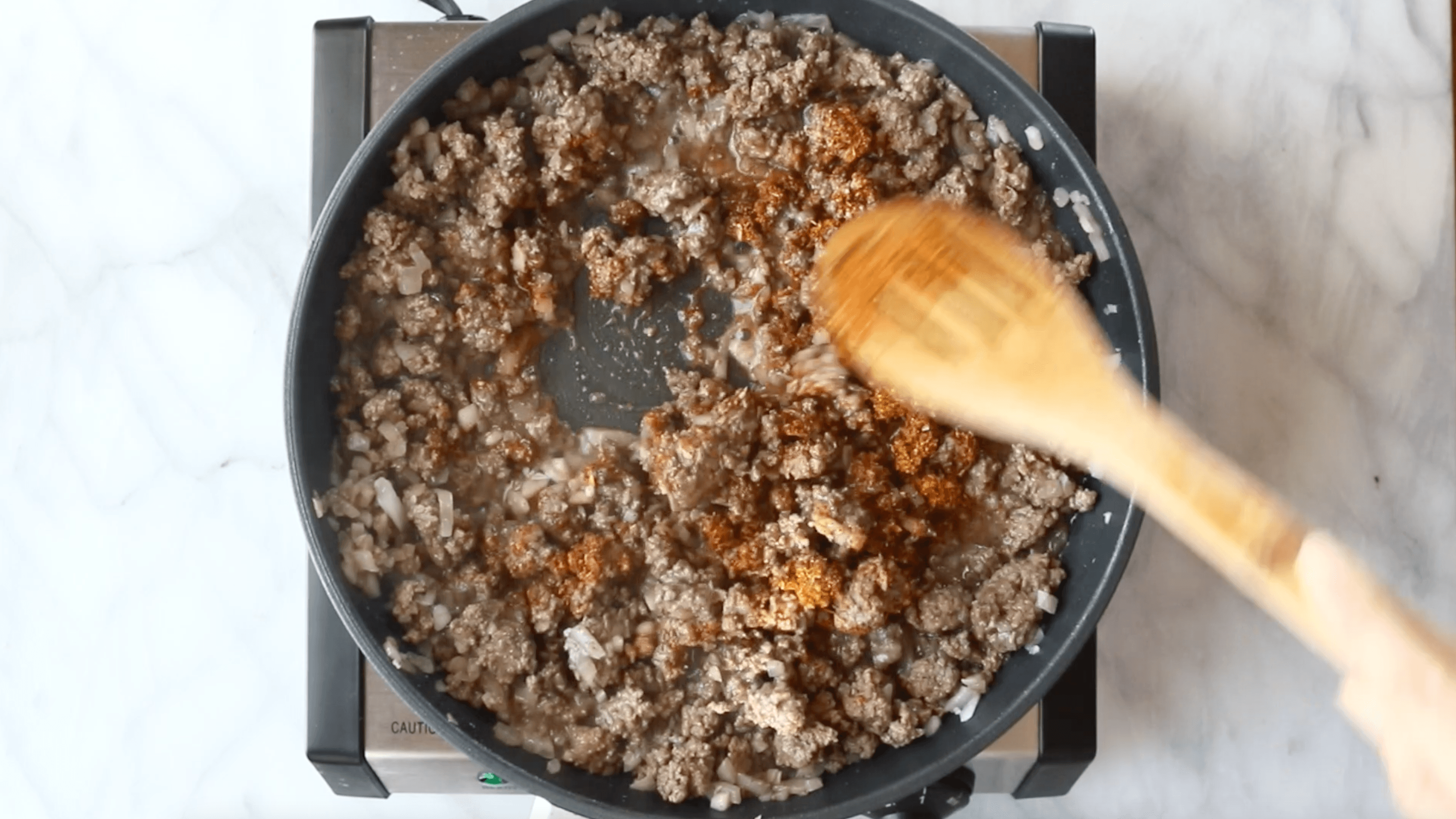 Ground beef in a skillet.