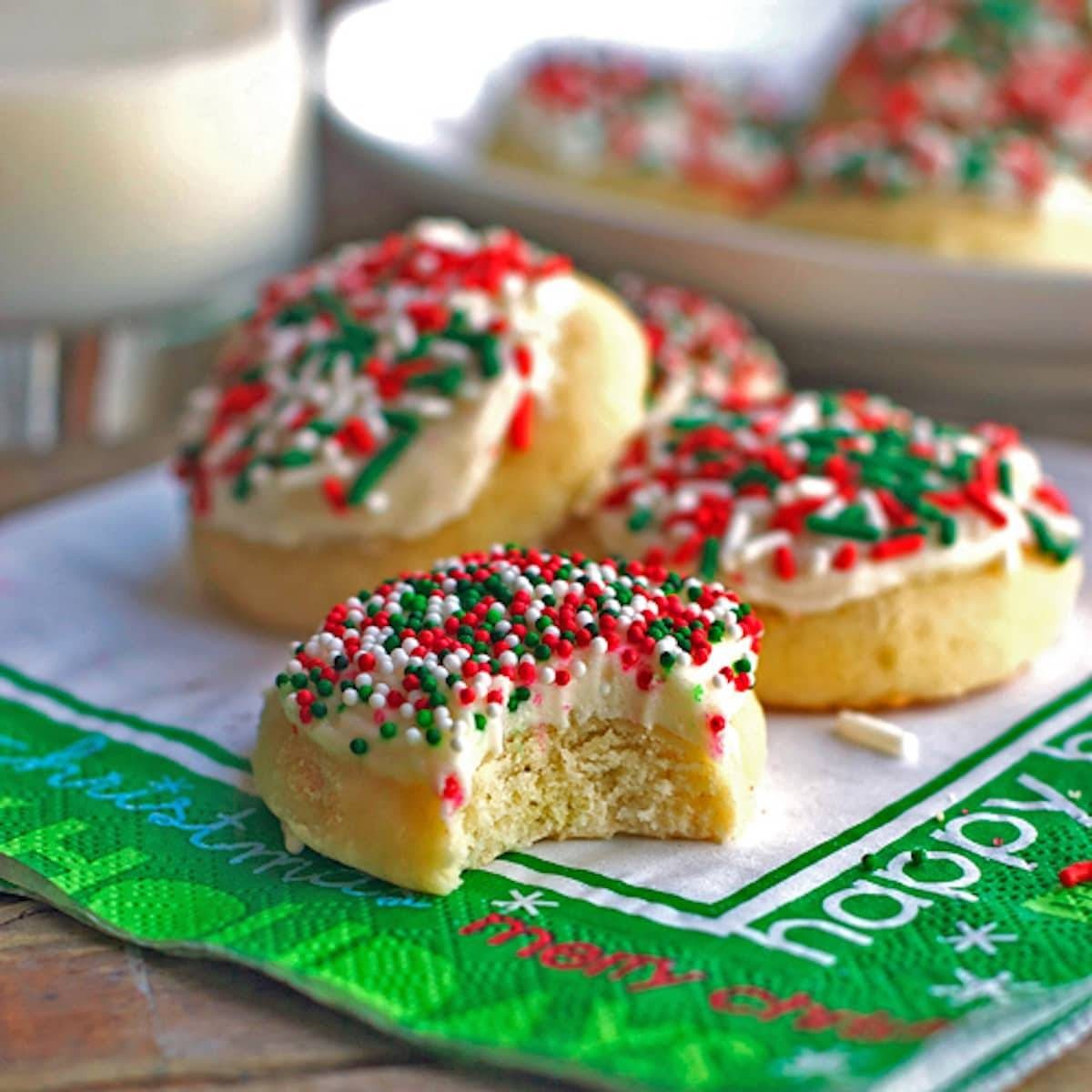 Fluffy sugar cookies topped with a vanilla frosting and sprinkles.